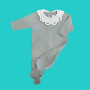 Gray baby onesie with a white scalloped collar on a teal background