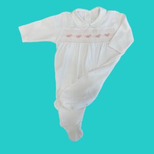 White baby onesie with pink bow embroidery across the chest on a teal background
