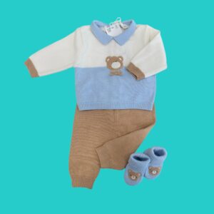 Baby knit sweater with light blue collar and color-block tan and blue design, featuring a teddy bear patch on the chest (paired with matching blue booties) on a teal background